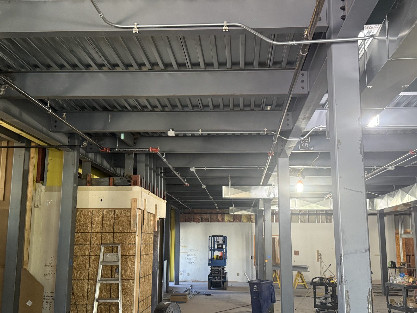 Electrical rough-in in progress across the steel structure of a commercial build-out by Arizona Electrical Solutions