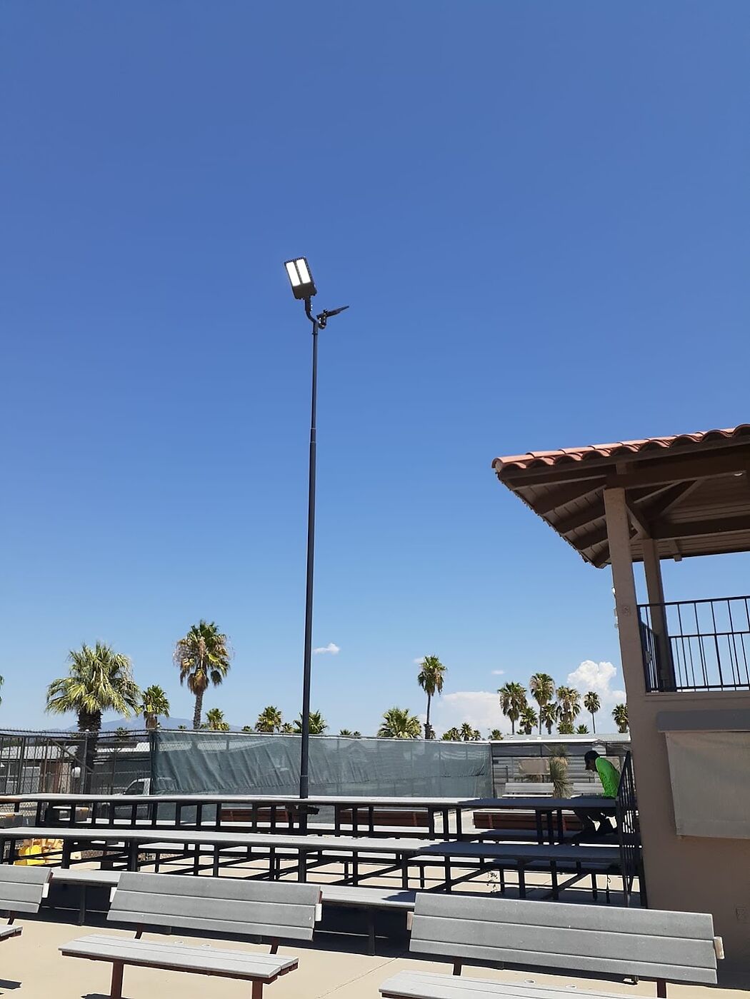 Close view of a new LED flood head mounted on an existing court light pole at an RV resort in Tucson, Arizona