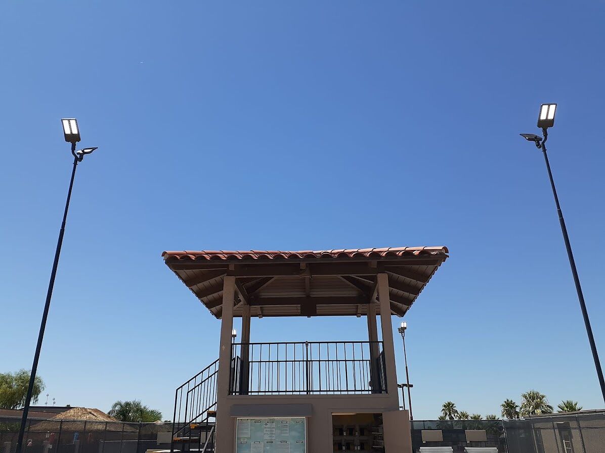New LED heads on poles flanking the covered observation tower between the courts at an RV resort in Tucson, Arizona
