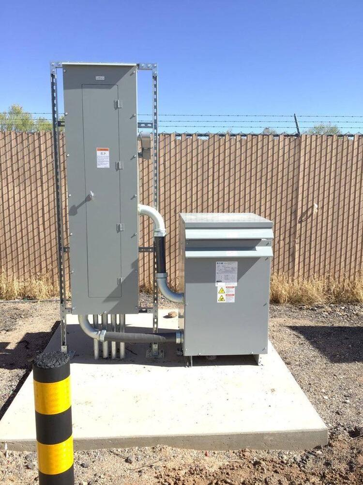 Service-entrance panel and transformer with conduit on a concrete pad