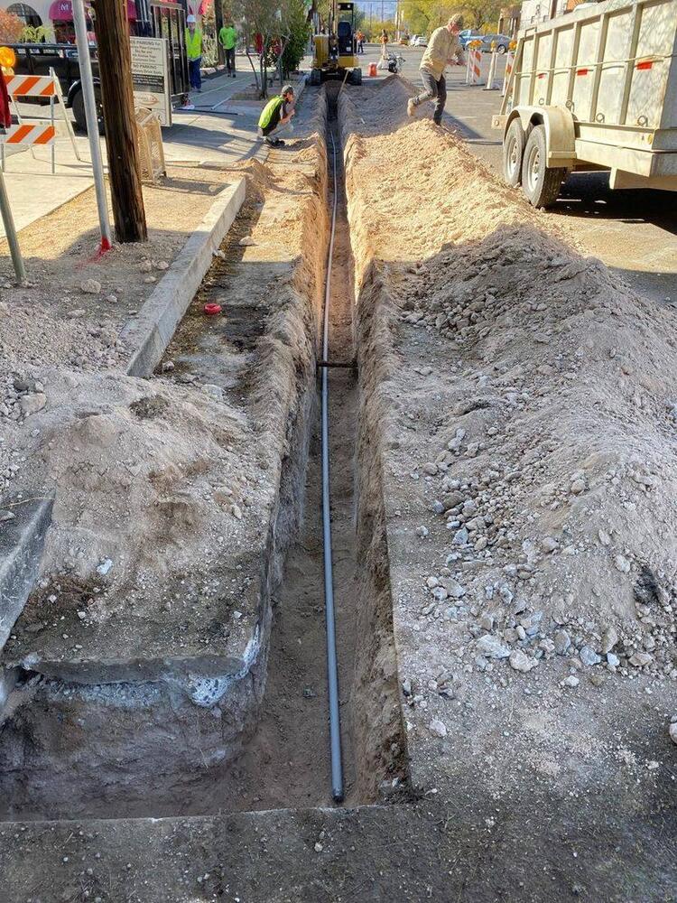 Underground conduit installed in an open street trench in Tucson, Arizona